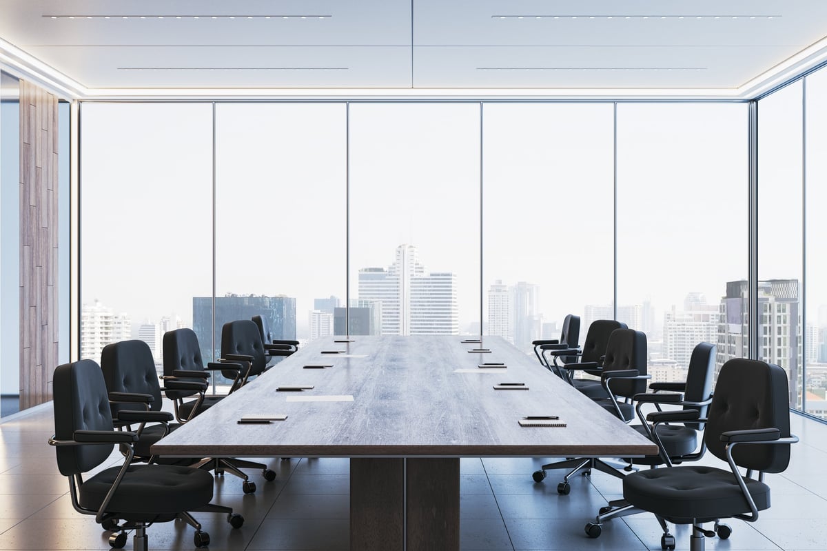 Spacious corporate boardroom with sleek chairs and floor-to-ceiling windows