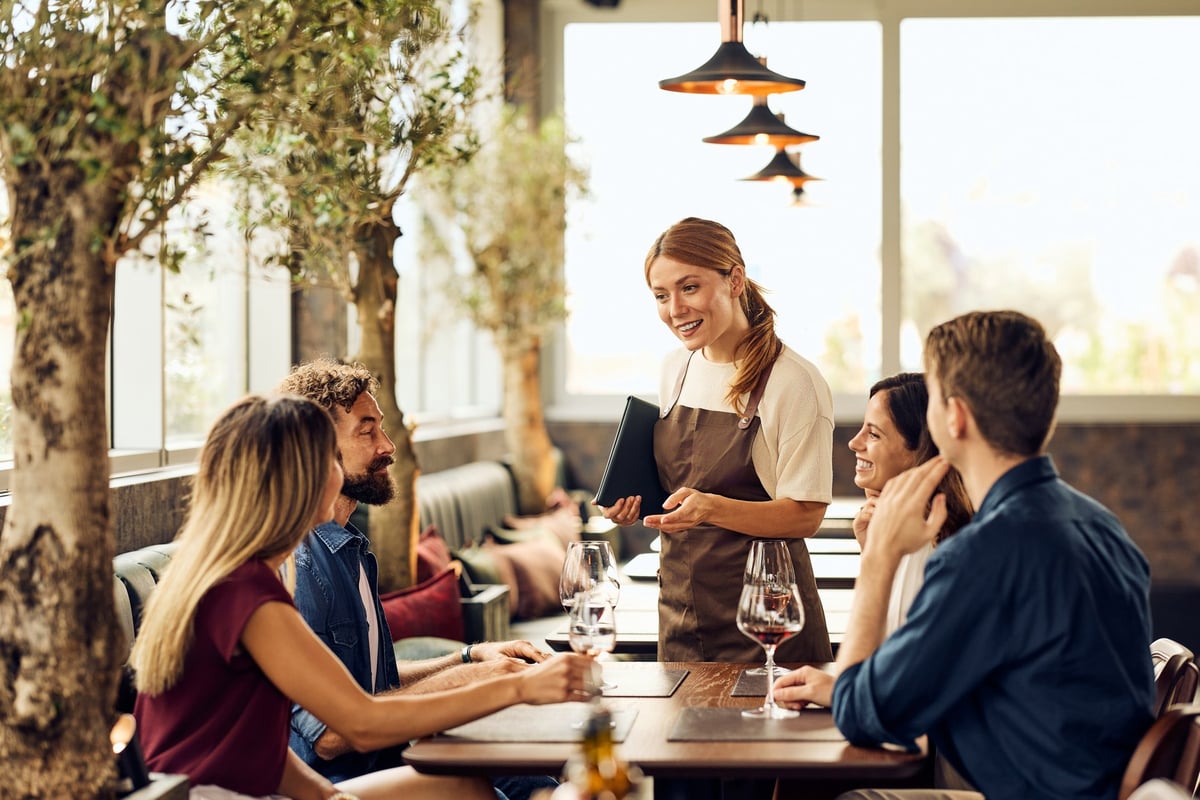 Group of friends enjoying a wonderful dining experience in a cozy restaurant environment