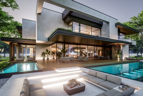 Modern two-story villa with pool and tropical landscaping at dusk